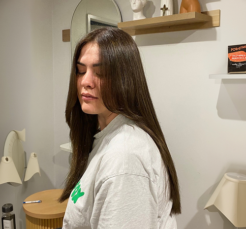 Long smooth dark brown hair styled straight, side profile view