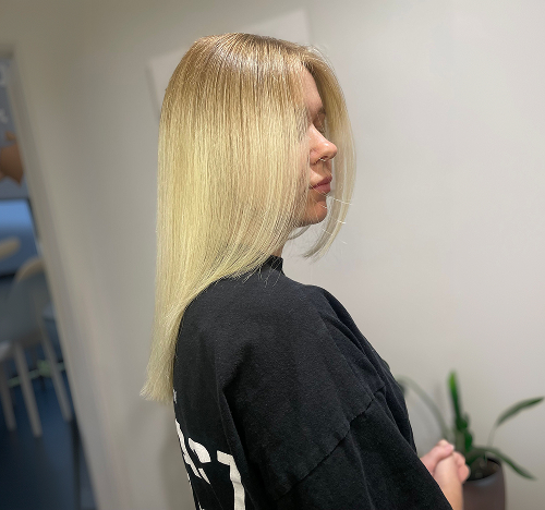 Sleek straight blonde hair styled at Salon Deelegance in Penrith, Sydney